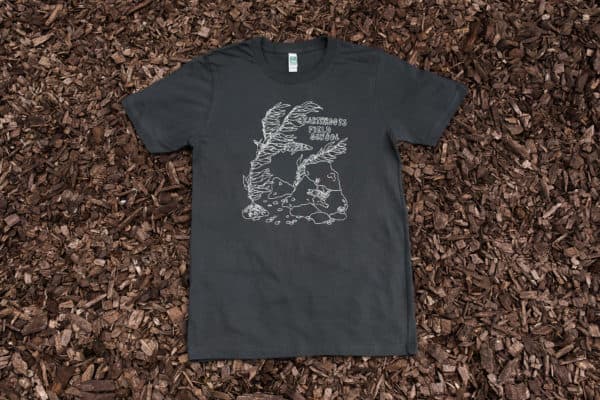Charcoal men's t-shirt with kelp and eel design on top of mulch