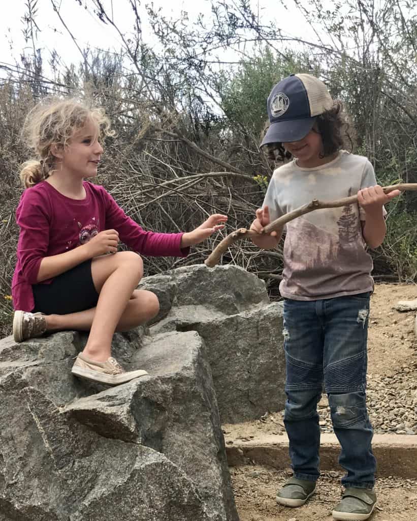 Two Homeschool Enrichment in Nature students relaxing and enjoying the outdoors
