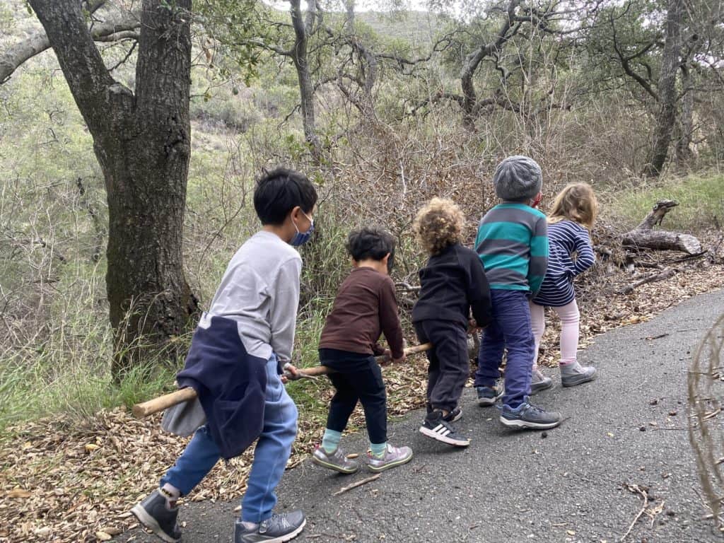 Forest Kindergarten students riding together on a stick
