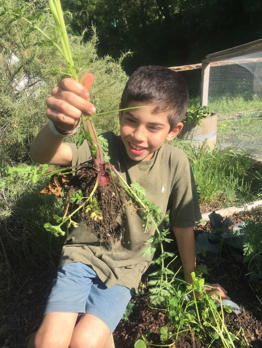 Earthroots student with local garden vegetables